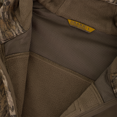 Close-up of MST Endurance Quarter Zip Jacket with Hood's interior, showcasing sherpa fleece panels, mesh lining, and Drake Waterfowl label, emphasizing comfort and breathability.