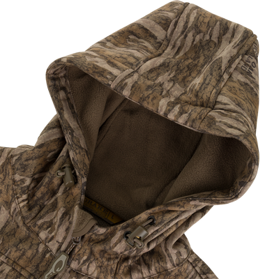 MST Endurance Quarter Zip Jacket with Hood featuring camouflage print, fleece-lined hood, zipper pull, and draw-cord toggles for adjustable fit, ideal for outdoor activities.
