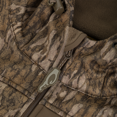 MST Endurance Quarter Zip Jacket with Hood, featuring a camo pattern, heavy-duty zipper, cord-lock toggle, and fleece lining, ideal for outdoor enthusiasts.