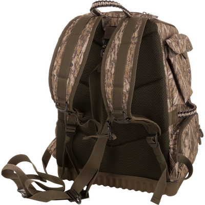 Tree Hugger Timber Pack, featuring a camo design, padded mesh back, adjustable straps, side pockets, ideal for rugged outdoor activities like hunting and hiking.