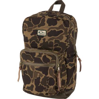 The Throwback 80 Backpack by Waterfowl in Old School Sport features two front zippered pockets, leather pulls, a DRAKE logo patch, top handle, side pocket, and a roomy interior for your essentials.