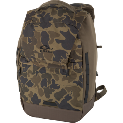 The Waterfowl CommandXT Quick Load Pack in Old School Sport features a durable, water-repellent camo design with multiple pockets, a ripstop bottom, top handle, adjustable straps, and a black Drake logo on the front.