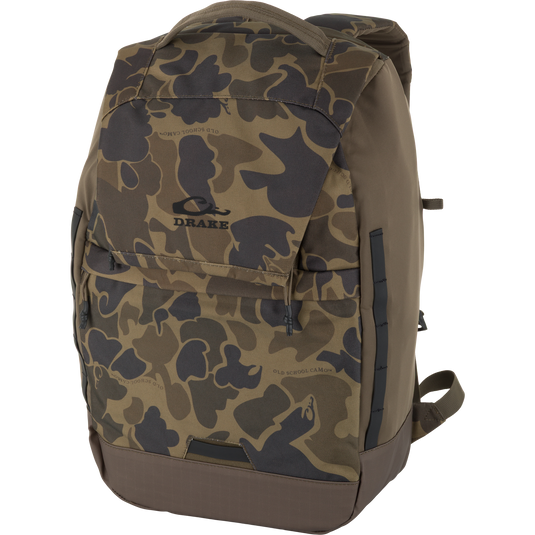 The Waterfowl CommandXT Quick Load Pack in Old School Sport features a durable, water-repellent camo design with multiple pockets, a ripstop bottom, top handle, adjustable straps, and a black Drake logo on the front.