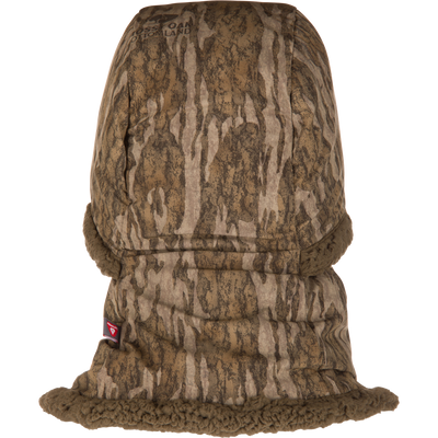 The LST BMF Balaclava with Primaloft by Waterfowl features brown tree-bark camo, fuzzy sherpa fleece trim, insulated fabric for cold weather, and a small side tag—ideal for hunting or outdoor use.