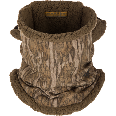 The Waterfowl LST BMF Balaclava with Primaloft features a brown and tan tree bark pattern, soft sherpa fleece lining, and a label inside the collar—ideal for cold weather.
