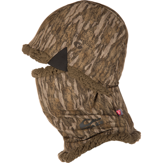 The Waterfowl LST BMF Balaclava with Primaloft features camo fabric, a split mouth opening, sherpa fleece lining, and elastic edges—ideal for outdoor activities in cold weather.