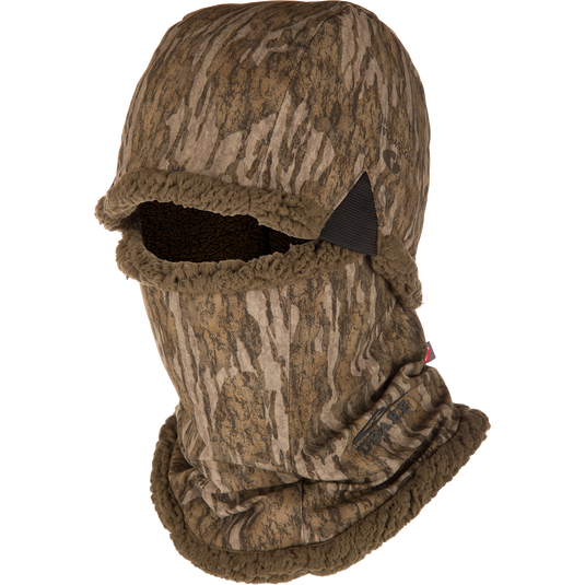 The Waterfowl LST BMF Balaclava with Primaloft in Mossy Oak Bottomland covers head and neck, leaving only the eyes and nose exposed—ideal for cold-weather concealment.
