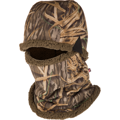 The LST BMF Balaclava with Primaloft by Waterfowl features Mossy Oak Original Shadow Grass camo and warm sherpa fleece, covering your head, neck, and lower face for cold-weather protection with an eye opening.