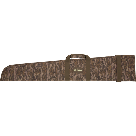 The Migrator Gun Case, a soft-shell camo-patterned rifle bag, features webbing straps, a central handle, and padded, waterproof 430gsm polyester for durable field protection.