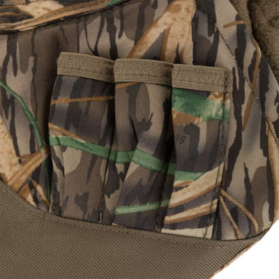 Close-up of the Waterfowl LST Handwarmer Muff, a camouflage fabric pouch with three vertical pockets in brown, green, and tan—ideal for outdoor gear and includes a waterproof cell phone pocket.