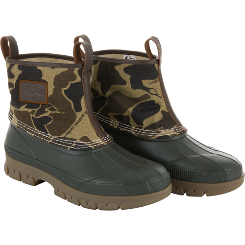 RTL - Throwback 80 Waxed Canvas Slip On Duck Boot with camouflage canvas, leather trim, waterproof rubber shell, and lugged outsole for durability and traction.