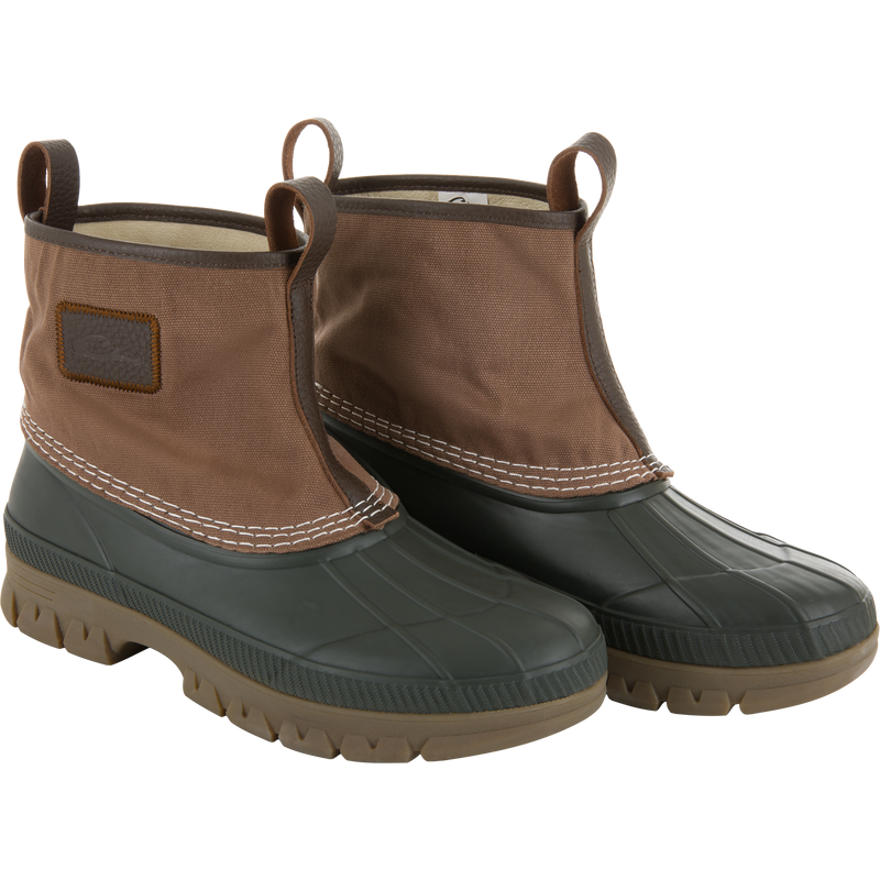 RTL - Throwback 80 Waxed Canvas Slip On Duck Boot, featuring a black rubber sole and brown canvas upper with leather trim and pull-on loops for durability.