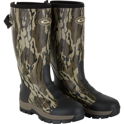 The Waterfowl EST Uninsulated 16″ Hybrid Mudder Boot 3.0 in Mossy Oak Original Bottomland features black soles and reinforced toe and heel areas, ideal for rugged outdoor use.