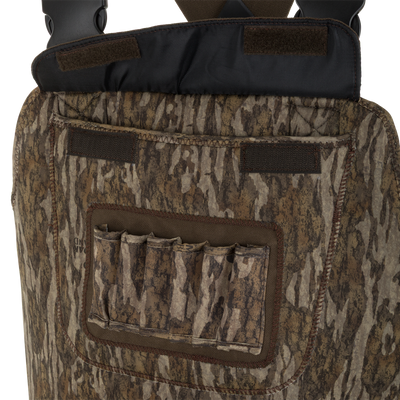 Close-up of camouflage-patterned fabric pocket with five shell holders on outdoor gear, likely the Waterfowl Youth Neoprene Wader featuring an adjustable belt.