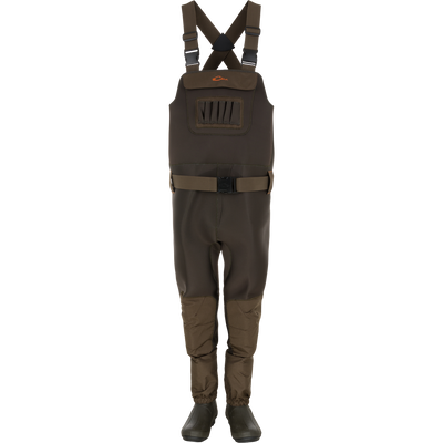 Waterfowl Youth Neoprene Wader in Green Timber shown upright against a white background, featuring adjustable suspenders and belt, front zip pocket, and built-in booties.