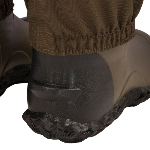 Close-up of Hardline Uninsulated Breathable Wader's rubber boot heel and outsole, showcasing durable design and waterproof pant cuff for outdoor reliability.