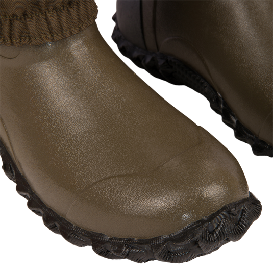 Close-up of Hardline Uninsulated Breathable Wader's olive-drab rubber toes, featuring elasticized cuff and scalloped outsole, showcasing durable design and waterproof features for outdoor adventures.