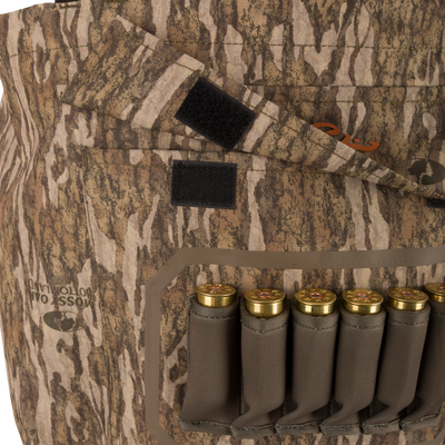 Hardline Breathable Youth Wader with Mossy Oak Bottomland camo, featuring elastic loops for shotgun shells and Velcro pocket closures, ideal for young outdoor enthusiasts.