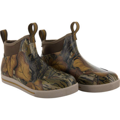 The Waterfowl Camp Deck Boot features a short, slip-on neoprene design with brown soles and a Mossy Oak Fall Foliage camo—ideal for outdoor adventures.