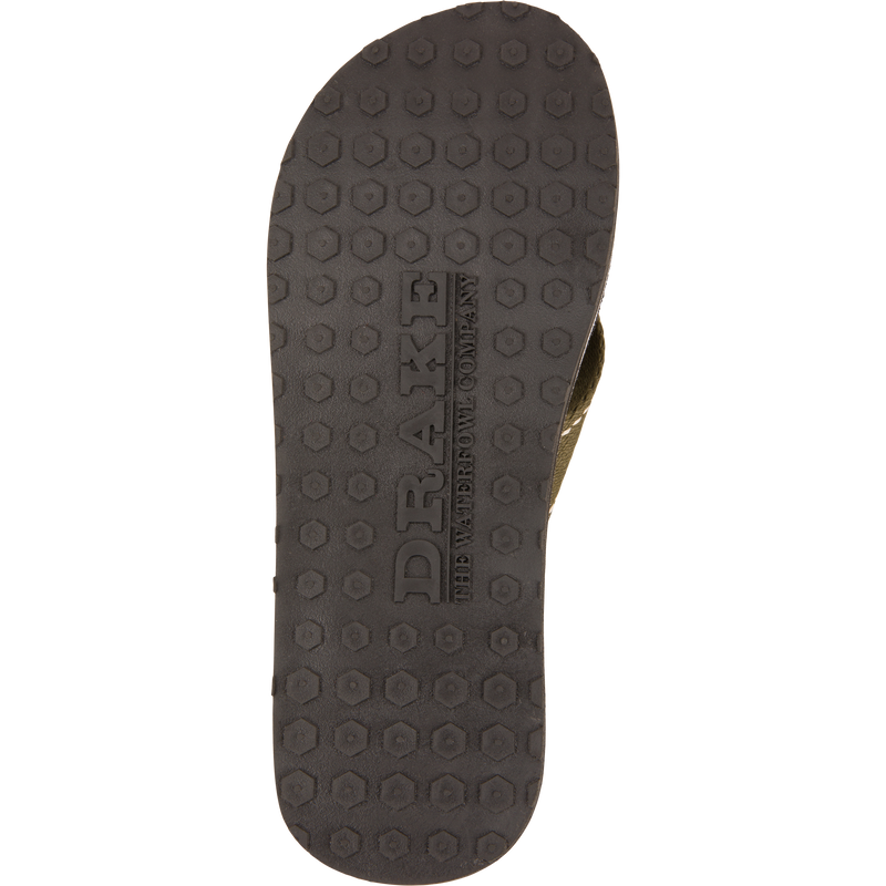 Underside of Lake Shore Flip Flops with black honeycomb tread, embossed with “DRAKE” and “The Waterfowl Company,” designed for outdoor and water adventures.