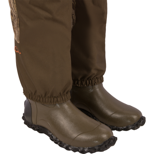 Close-up of legs in Hardline Insulated Breathable Wader with elastic-cuffed pants and boots, showcasing durable, waterproof design ideal for outdoor adventures.