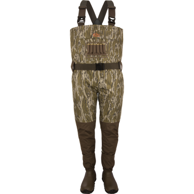 The Waterfowl Hardline Insulated Breathable Wader in Mossy Oak Original Bottomland features attached Thinsulate rubber boots, black adjustable suspenders, a dark belt, and chest loops on a white backdrop.