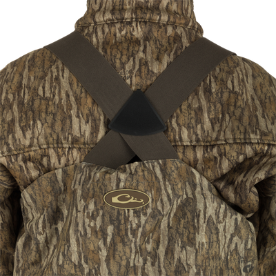 Person wearing the Insulated Guardian Elite HND Front Zip Wader, showcasing its camouflage design and reinforced taped seams for durability.