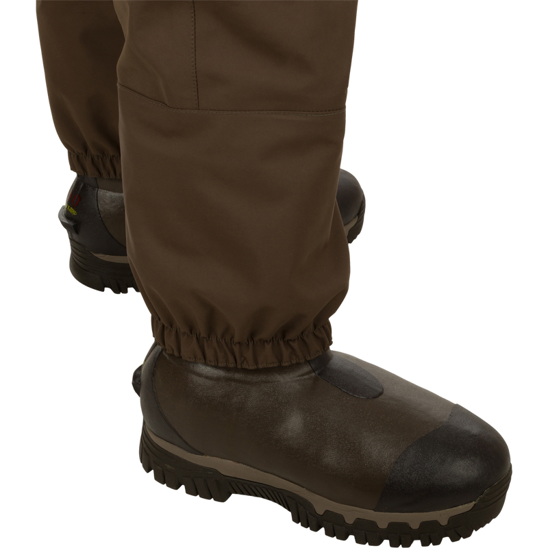 Insulated Guardian Elite HND Front Zip Wader with brown boots, featuring a waterproof vertical zipper and reinforced seams for durability and comfort in cold weather.