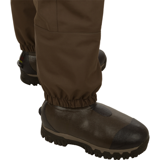Insulated Guardian Elite HND Front Zip Wader with brown boots, featuring a waterproof vertical zipper and reinforced seams for durability and comfort in cold weather.