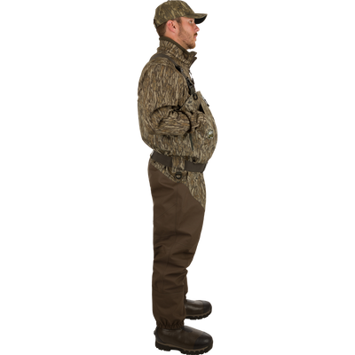 Man wearing Insulated Guardian Elite HND Front Zip Wader, showcasing durable camouflage clothing with reinforced seams and Thinsulate®-lined boots for warmth and comfort in cold weather.