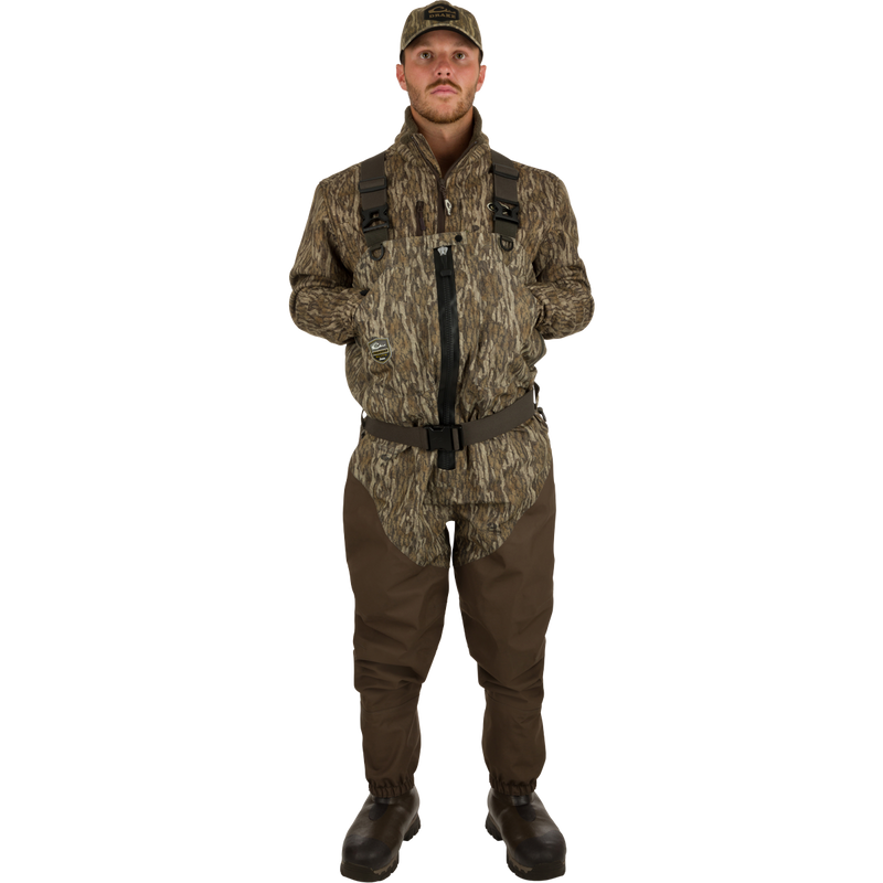 Man wearing Insulated Guardian Elite HND Front Zip Wader, showcasing durable camouflage outfit with reinforced seams and Thinsulate® lined boots for cold weather hunting.