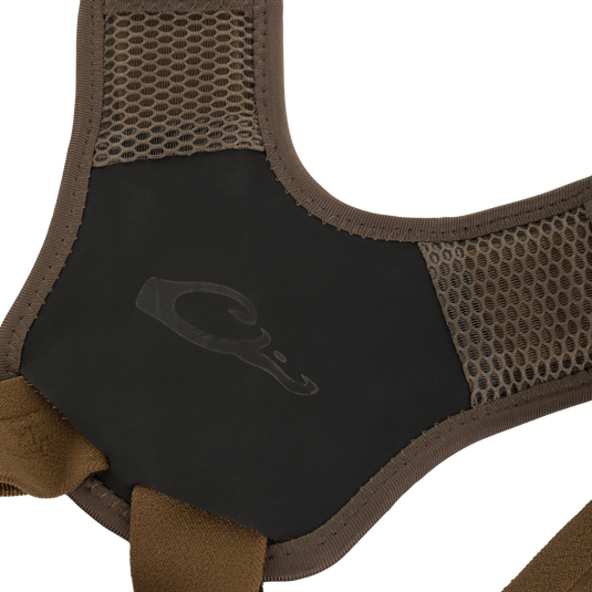 Close-up of brown mesh shoulder straps on a Drake X Ducks Unlimited BMF1600 Kevlar Wader, connected to a black chest panel with a duck head logo.