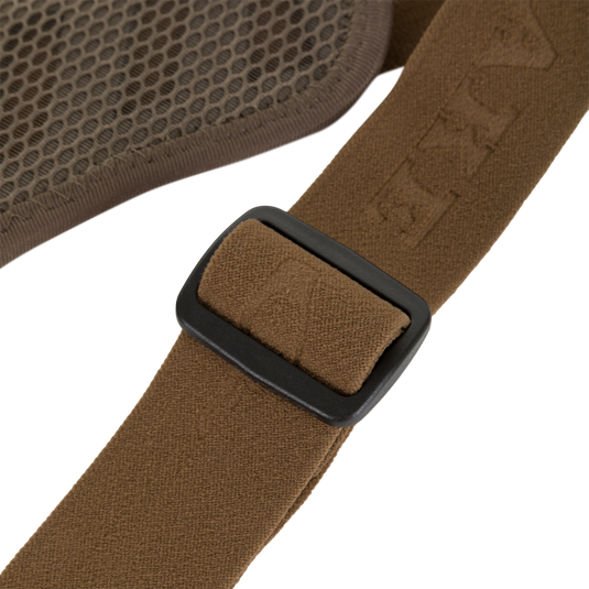 Close-up of a brown strap with an adjustable black plastic buckle attached to the textured mesh panel of a Drake X Ducks Unlimited BMF1600 Kevlar Wader.