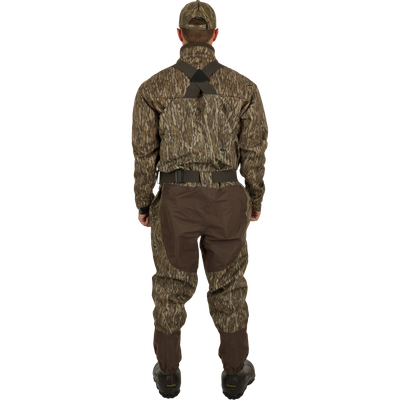 A man wearing the Insulated Guardian Elite Vanguard Breathable Waders, showing the back.