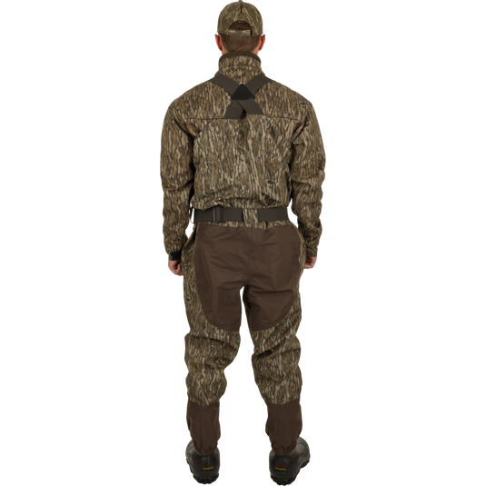 A man wearing the Insulated Guardian Elite Vanguard Breathable Waders, showing the back.