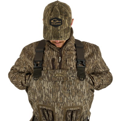 A man wearing the Insulated Guardian Elite Vanguard Breathable Waders.