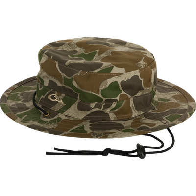 The Waterfowl Duk Boonie Hat in Old School Green features a military-inspired design with a wide brim and adjustable chin strap, shown on a white background.