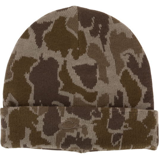 LST Acrylic Beanie from Drake Waterfowl: Camouflage knit fabric with 3mm foam stitch, featuring a flat stitch Drake logo. Ideal for outdoor activities, one-size-fits-most design for comfort.