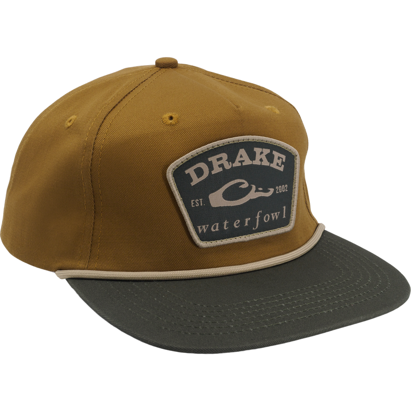 Drake X Lost Hat Drake Patch Goat Rope Cap with tan crown, olive bill, sewn patch, adjustable snap-back, and flat visor, blending comfort and structure.