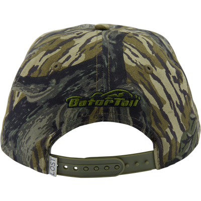 A Drake x Lost Hat MBRGA Patch Goat Rope Cap by Waterfowl, shown from the back with an adjustable green strap and “GatorTail” embroidered in green and black above the opening.