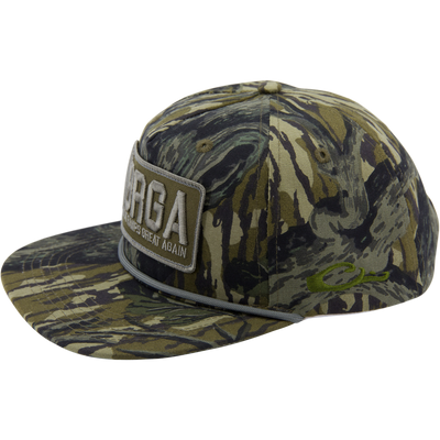 The Drake x Lost Hat MBRGA Patch Goat Rope Cap by Waterfowl features a camo design, front patch embroidery, decorative rope above the brim, and an adjustable snapback for a perfect fit.
