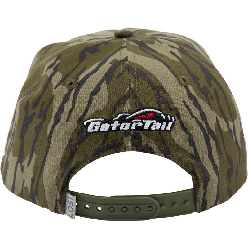 Back view of Drake x Lost Hat MBRGA Hybrid Patch Goat Rope Cap, showing olive-green camouflage, snap-closure, and Go for it! embroidered patch above the opening.