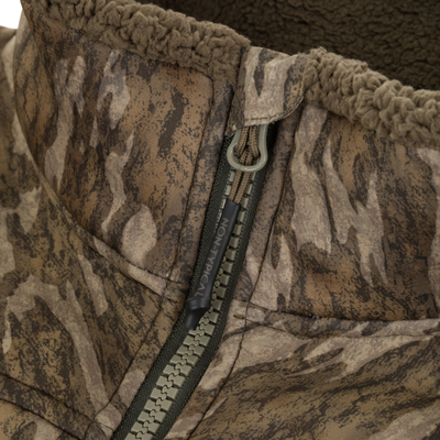 Close-up of a Non-Typical Midweight Nova Silencer Jacket with Scent Control by Nontypical, featuring green and beige zip, textured sherpa fleece lining, anti-odor tech, and detailed collar stitching.