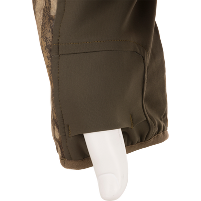 A close-up of an olive green sleeve cuff with camo detail on a white mannequin, from the Non-Typical Midweight Nova Silencer Jacket with Scent Control by Nontypical.