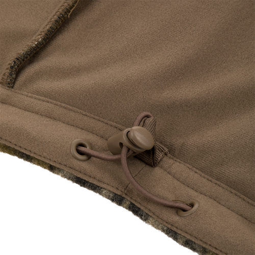 Close-up of Midweight Hydrowool Softshell Jacket hem with drawcord and cord-lock, showcasing windproof, waterproof design for outdoor adventures.
