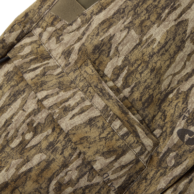 Close-up of the Non-Typical SWT Pant with Scent Control from Sale, featuring brown and tan camouflage stretch fabric, a flap pocket for durability, and faint text visible on the lower right.