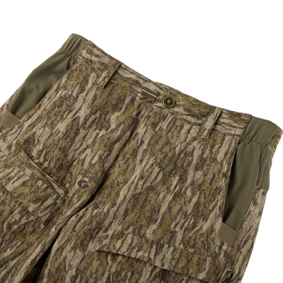 The Sale Non-Typical SWT Pant with Scent Control features a camo pattern, olive green side panels, large front pockets, a single button waist, and SWT stretch fabric for comfort and flexibility.