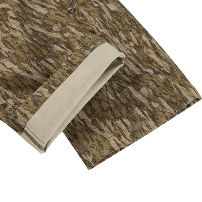 Close-up of brown and green camo-patterned Non-Typical SWT Pant with Scent Control by Sale, showing a folded edge, beige lining, and stitching—ideal for odor control and water resistance.