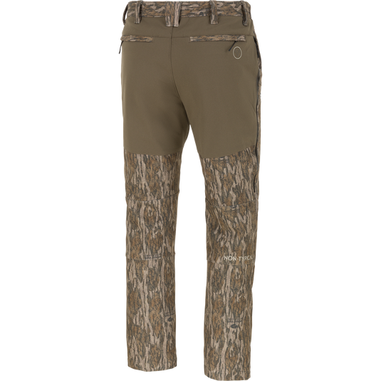 Back view of olive green Non-Typical Pursuit Softshell Pant with Agion Active X2 hunting pants, featuring a camouflage pattern on the lower legs and waistband.