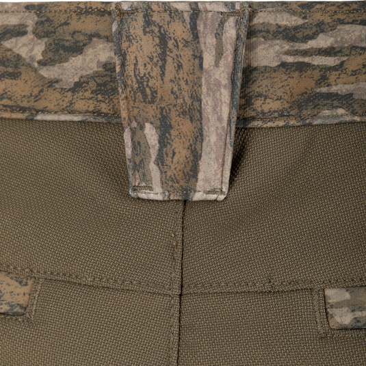 Close-up of olive green Non-Typical Pursuit Softshell Pant with Agion Active X2 tactical softshell pants featuring a camouflage patterned waistband and belt loop.